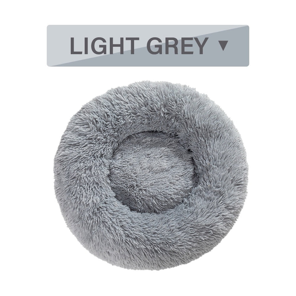 Light grey fluffy donut dog bed with ultra-plush, calming design for cats and dogs, washable and available in multiple sizes.