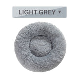 Light grey fluffy donut dog bed with ultra-plush, calming design for cats and dogs, washable and available in multiple sizes.
