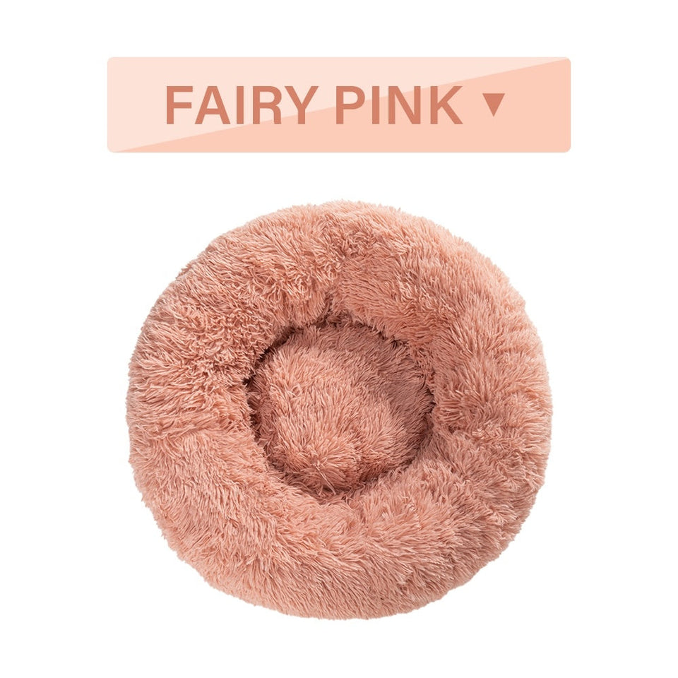 Fairy pink fluffy donut dog bed with ultra-plush fabric and raised rim for calming comfort.